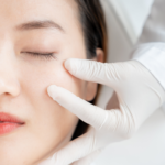 A consultation featuring a specialist in white gloves examining a patient's face to determine cosmetic surgery cost in Vietnam for facial rejuvenation and aesthetic procedures.