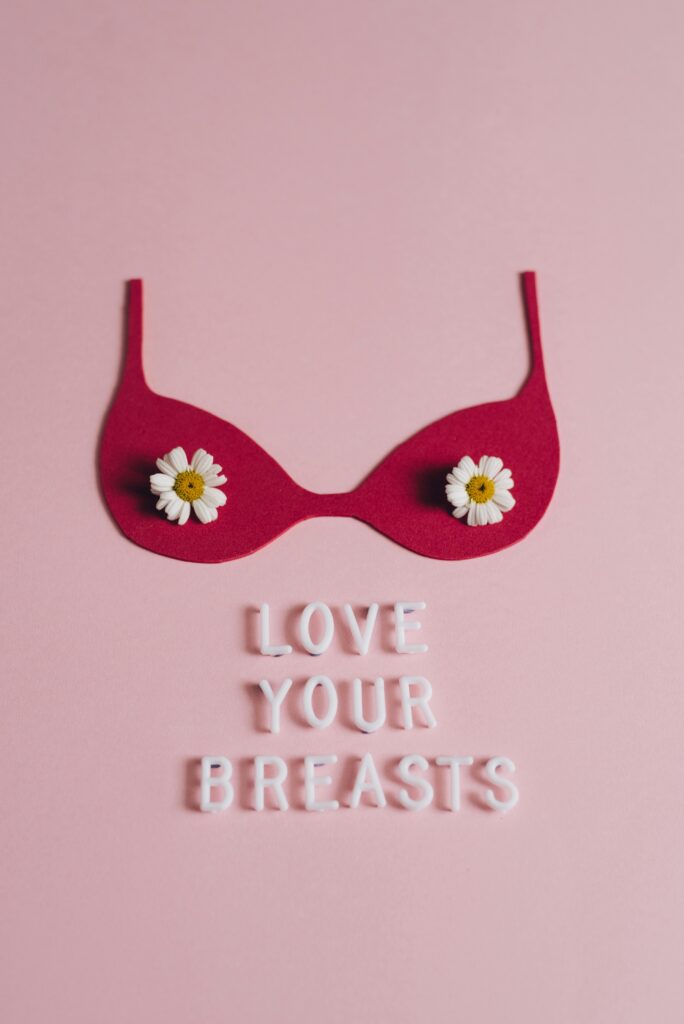 Conceptual art piece promoting breast cancer awareness with pink background and affirming message.